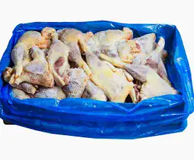 Fresh frozen chicken wings in blue plastic bag for wholesale supply.
